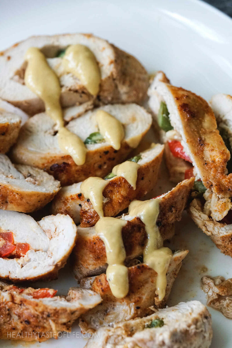 Healthy Stuffed Chicken roll Ups sliced on a platter.