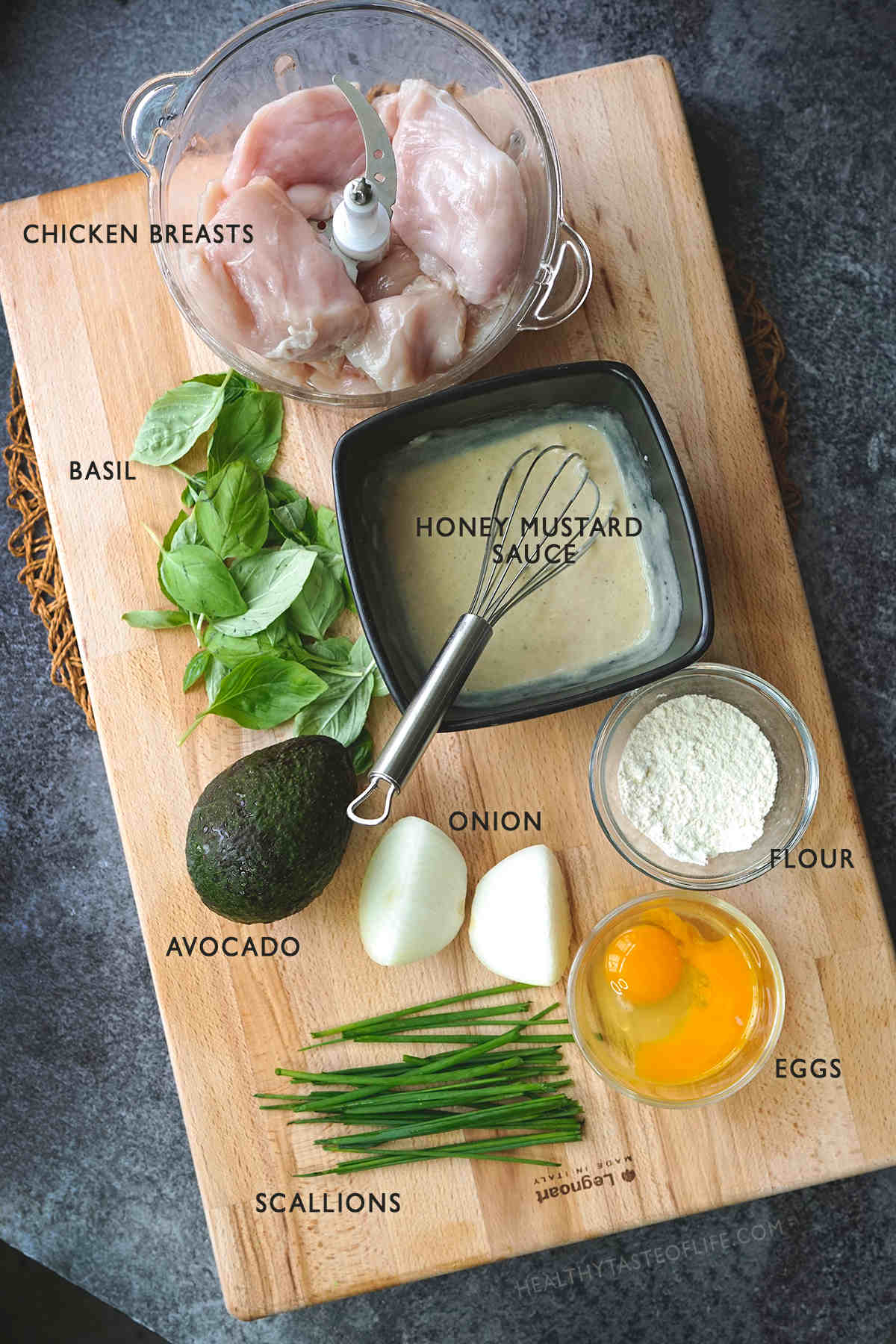 All ingredients necessary for making these chicken fritters displayed on a board for visual representation.
