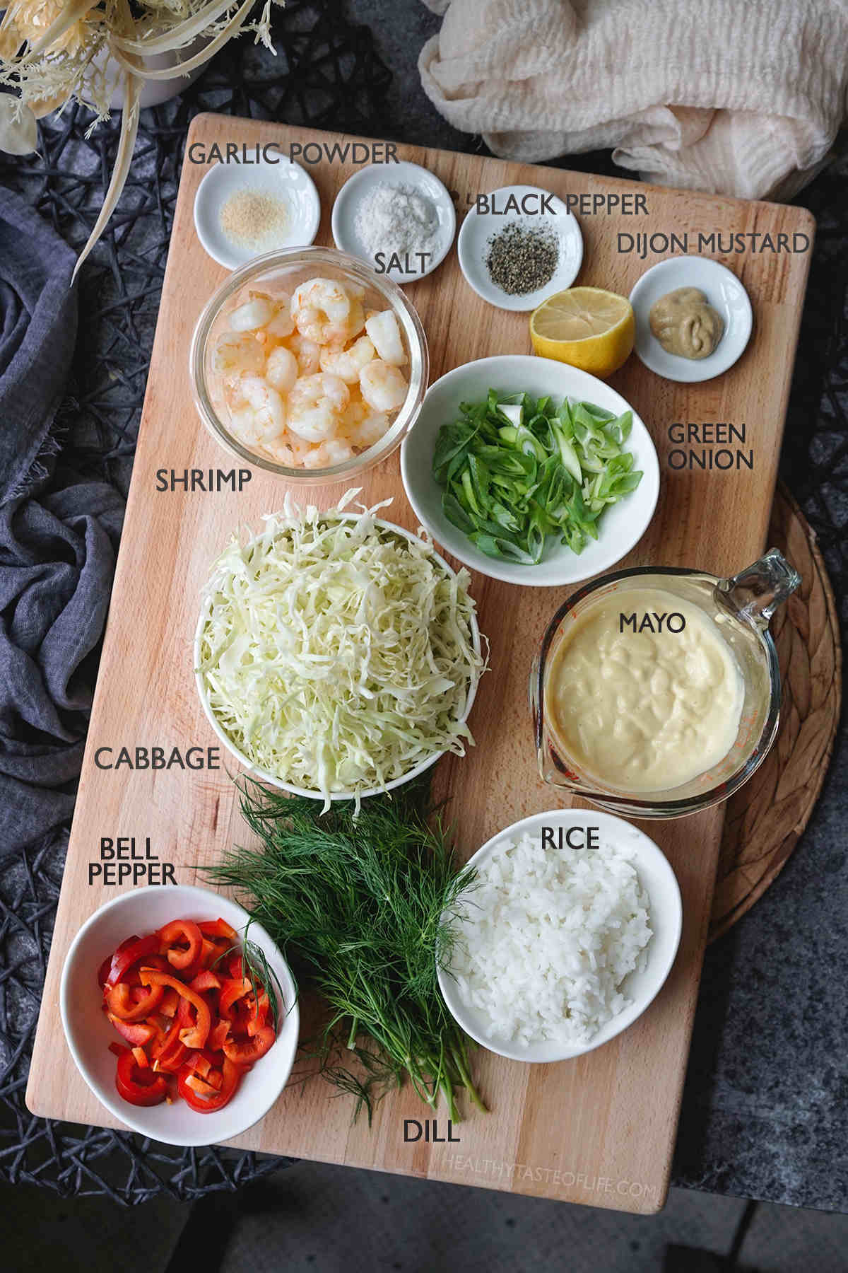 Measured ingredients needed for making this shrimp cabbage salad - shown displayed on a board.