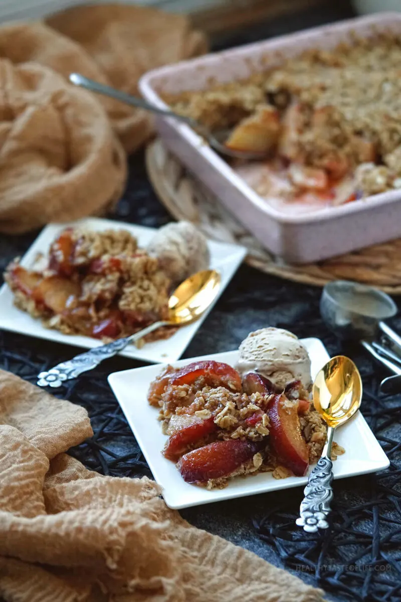 Apple And Plum Crumble served with ice cream.