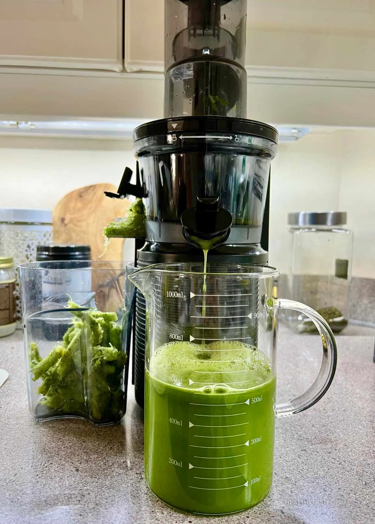 Juicing pineapple and celery in a juicer - photo showing the process.