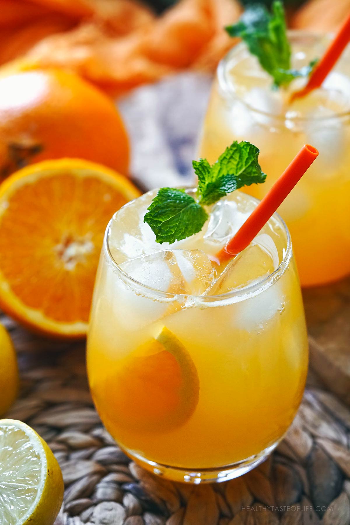 Orange lemonade served in a stemless large glass.