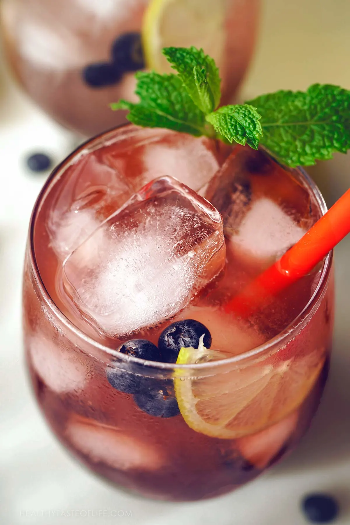 Close up shot of elderberry lemonade in a glass.