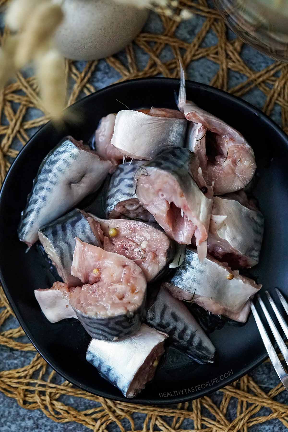 Fermented mackerel fish sliced on a plate shot above head.