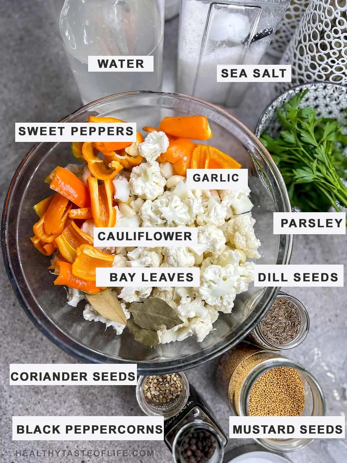 Ingredients needed to ferment cauliflower displayed on a table.