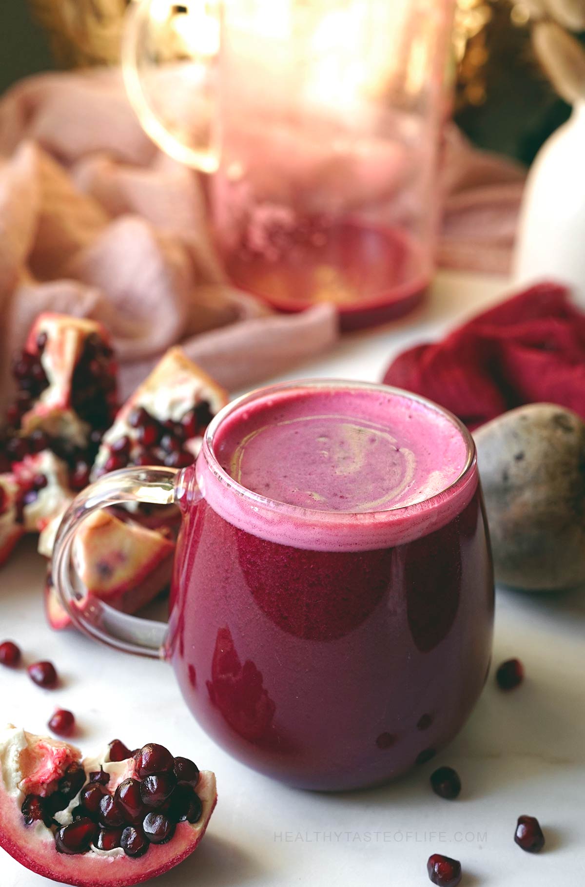 Beet and pomegranate juice in a glass mug.