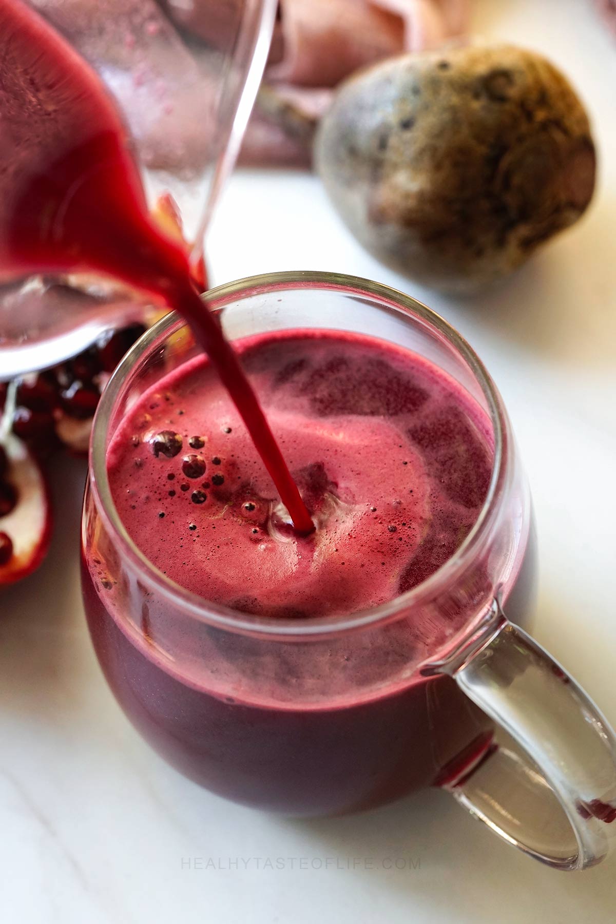 pouring beet and pomegranate juice