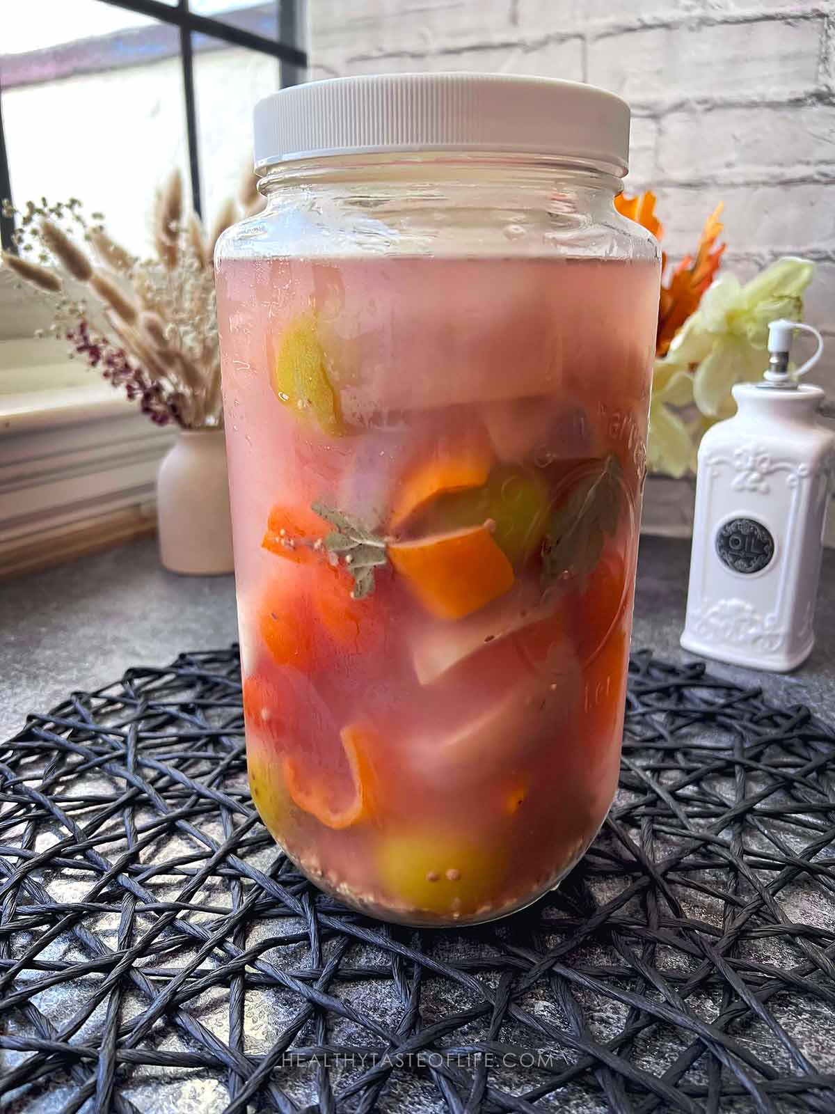 Peppers and tomatoes ferementing process jar