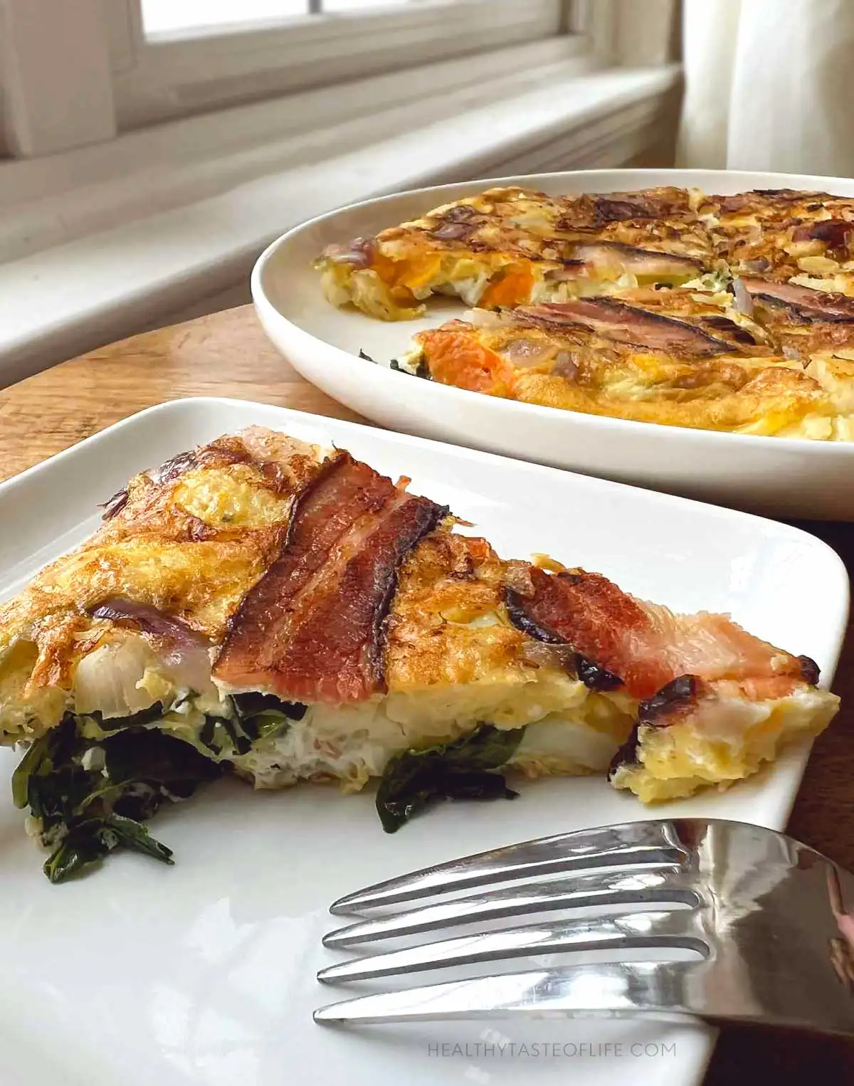 A close up photo of a slice of omelette showing texture inside.