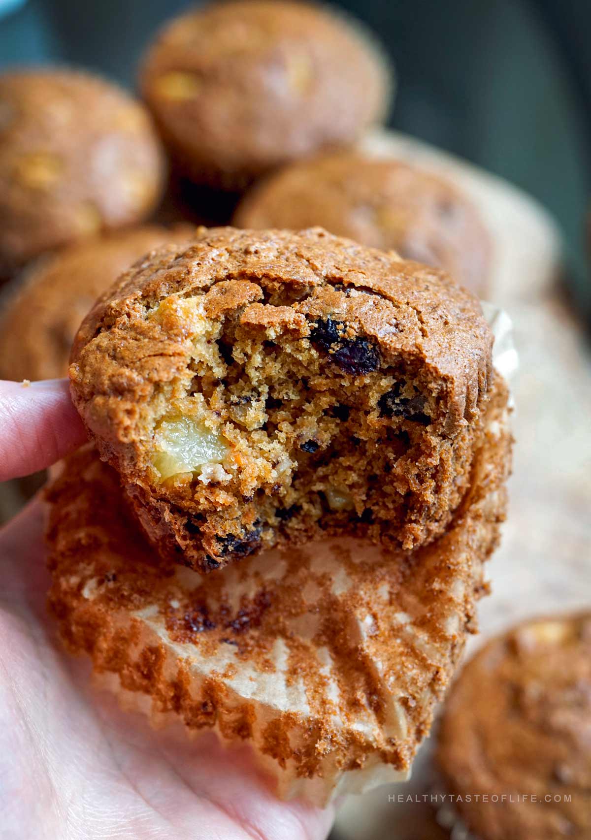Gluten-free carrot pineapple muffin bitten showing moist crumb