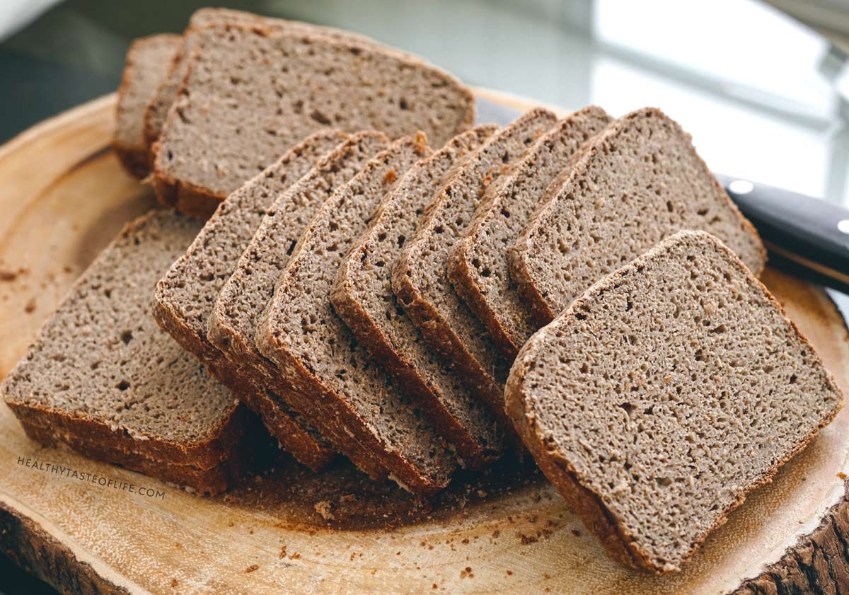Hearty gluten free sourdough bread with sorghum buckwheat and banana flour sliced on a board