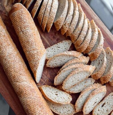 Slices of gluten free baguette on a board featured images