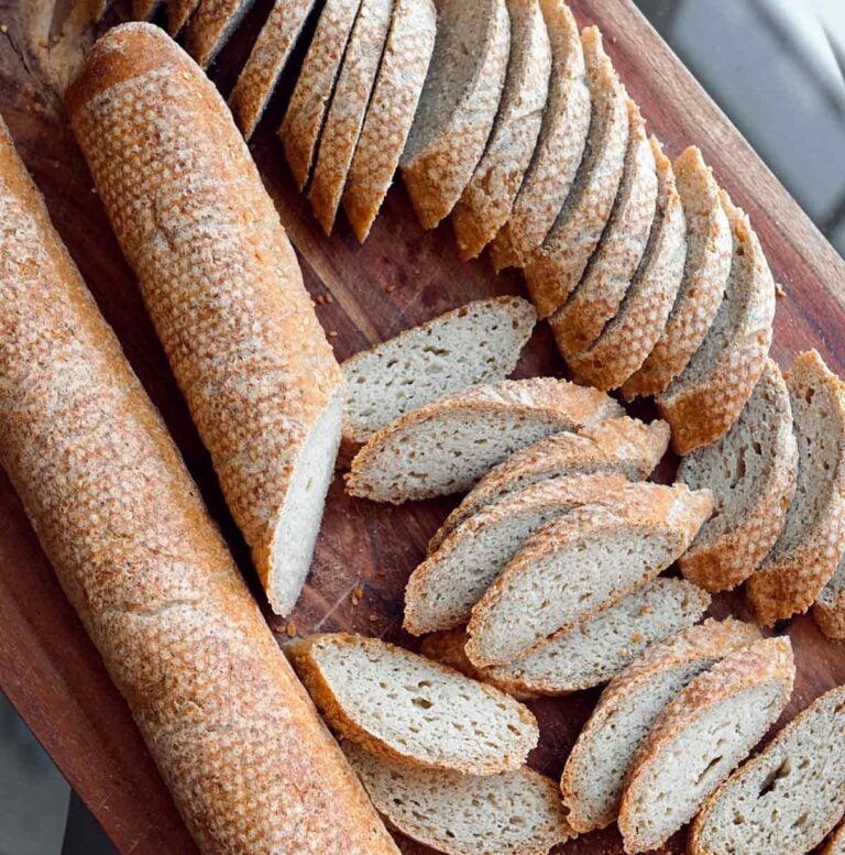 Slices of gluten free baguette on a board featured images