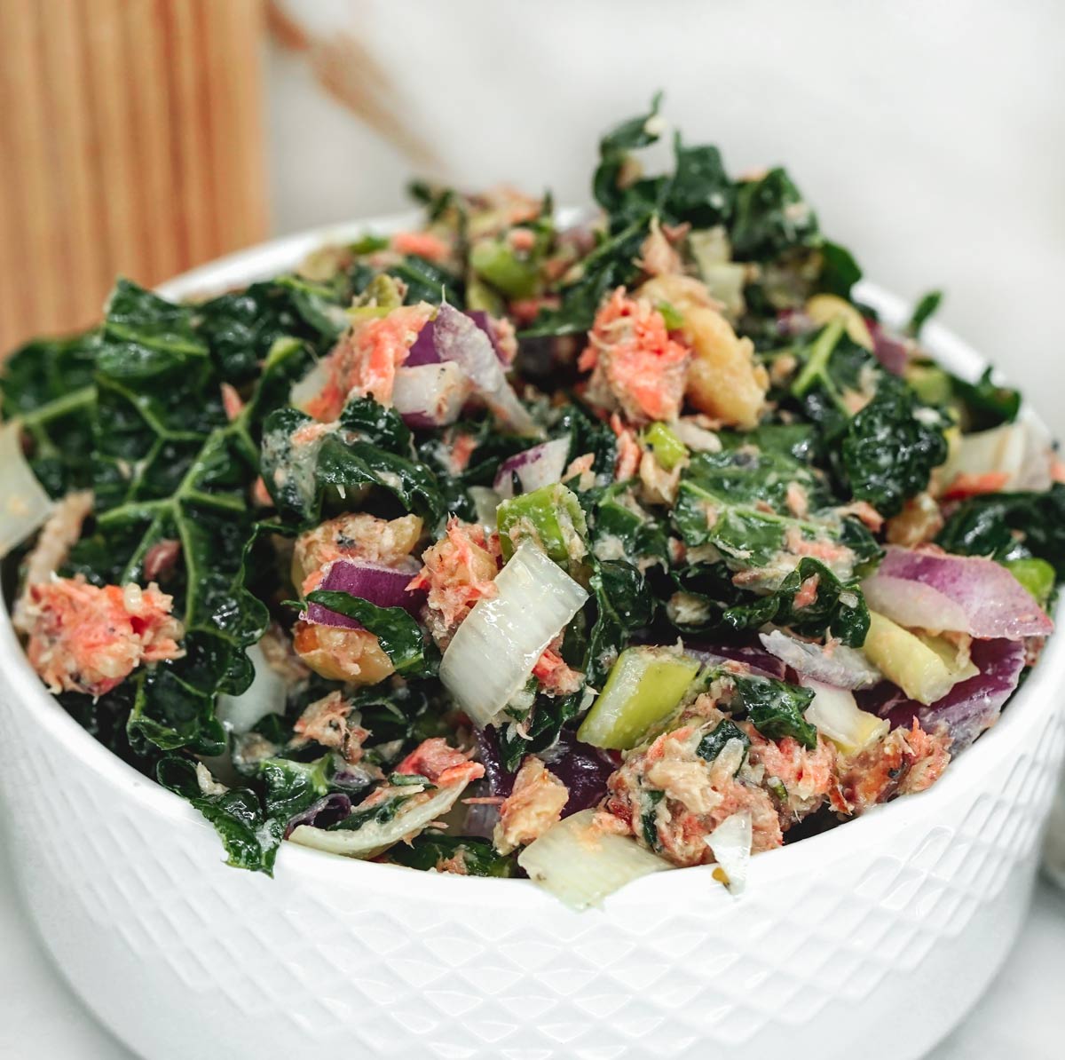 High protein salmon salad with sardines and veggies and a creamy sauce served in a bowl