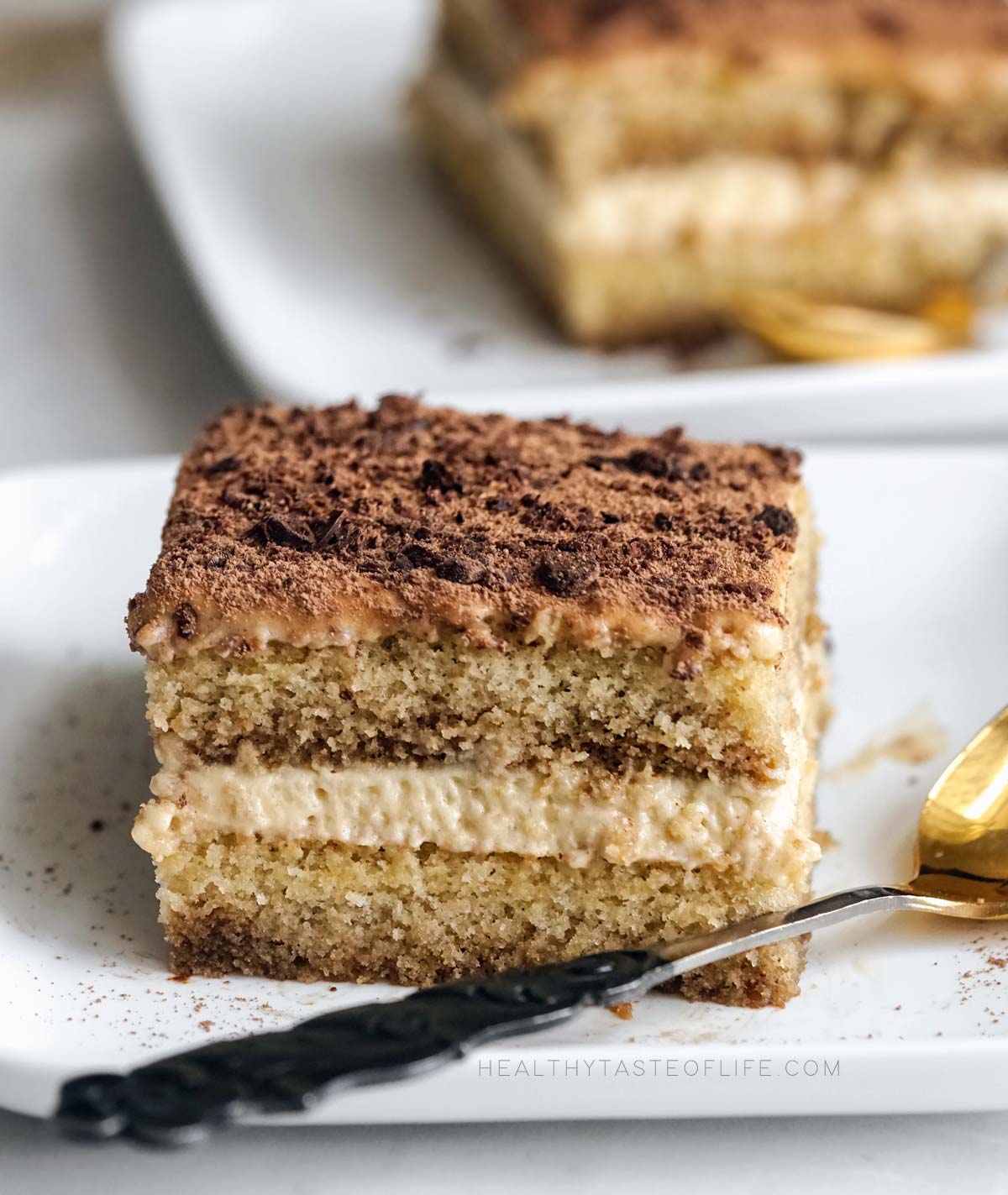 A slice of dairy free tiramisu made with gluten free sponge cake