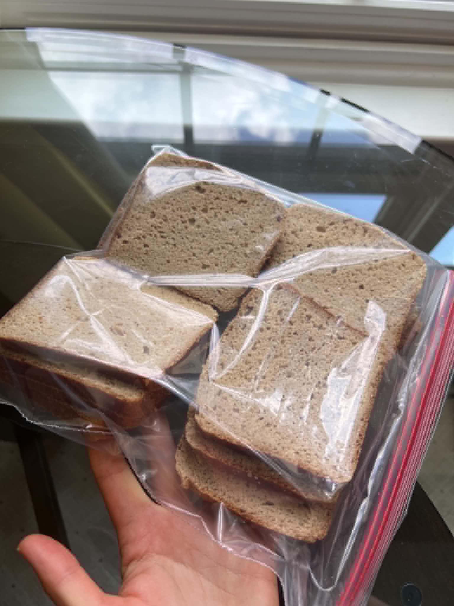 Sliced bread in a bag prepared for freezing.