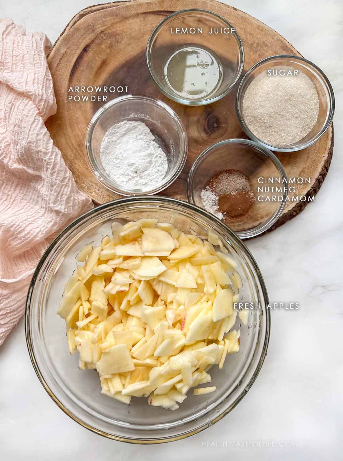Ingredients for apple filling for homemade apple cobbler Thinly sliced apples, sugar, arrowroot, lemon juice, spices