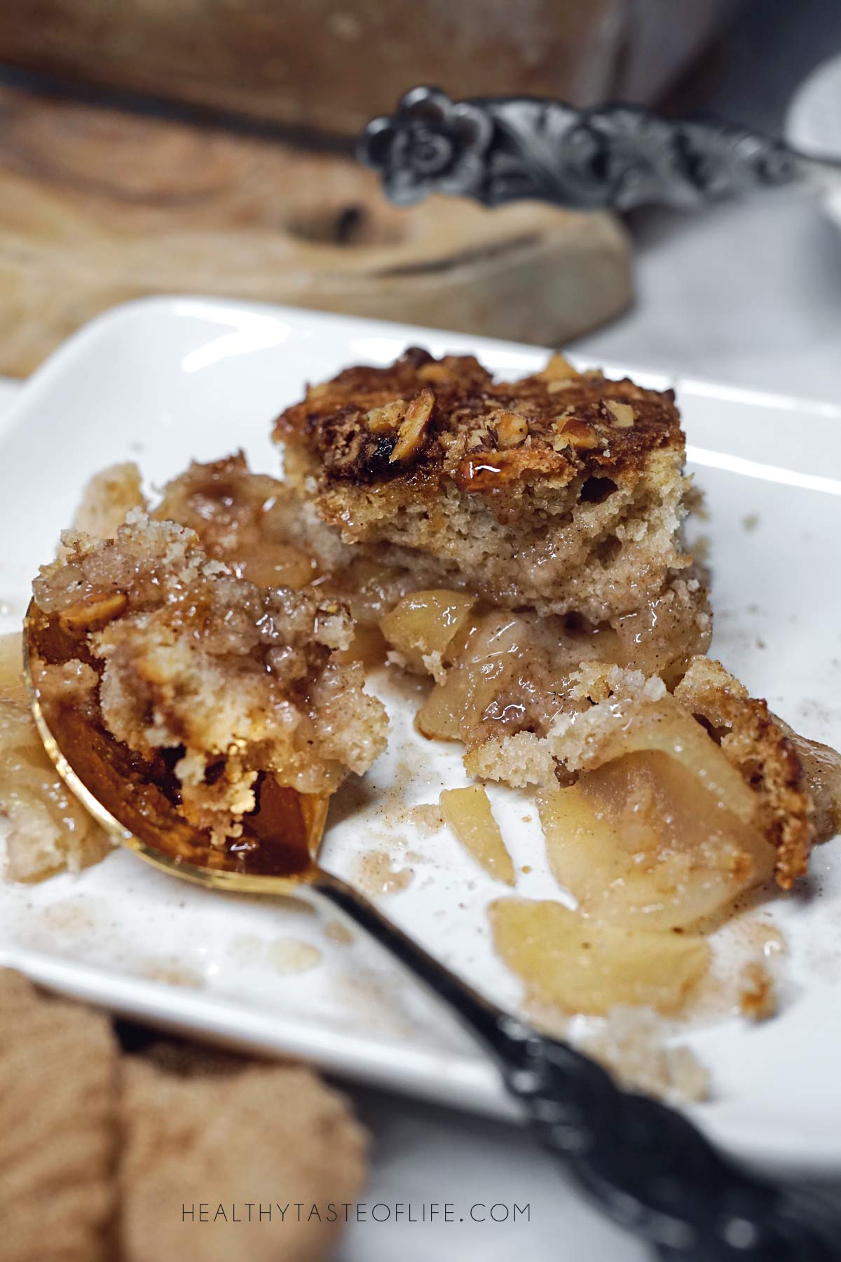 a bite of dairy free apple cobbler with fresh apples served warm for fall dessert